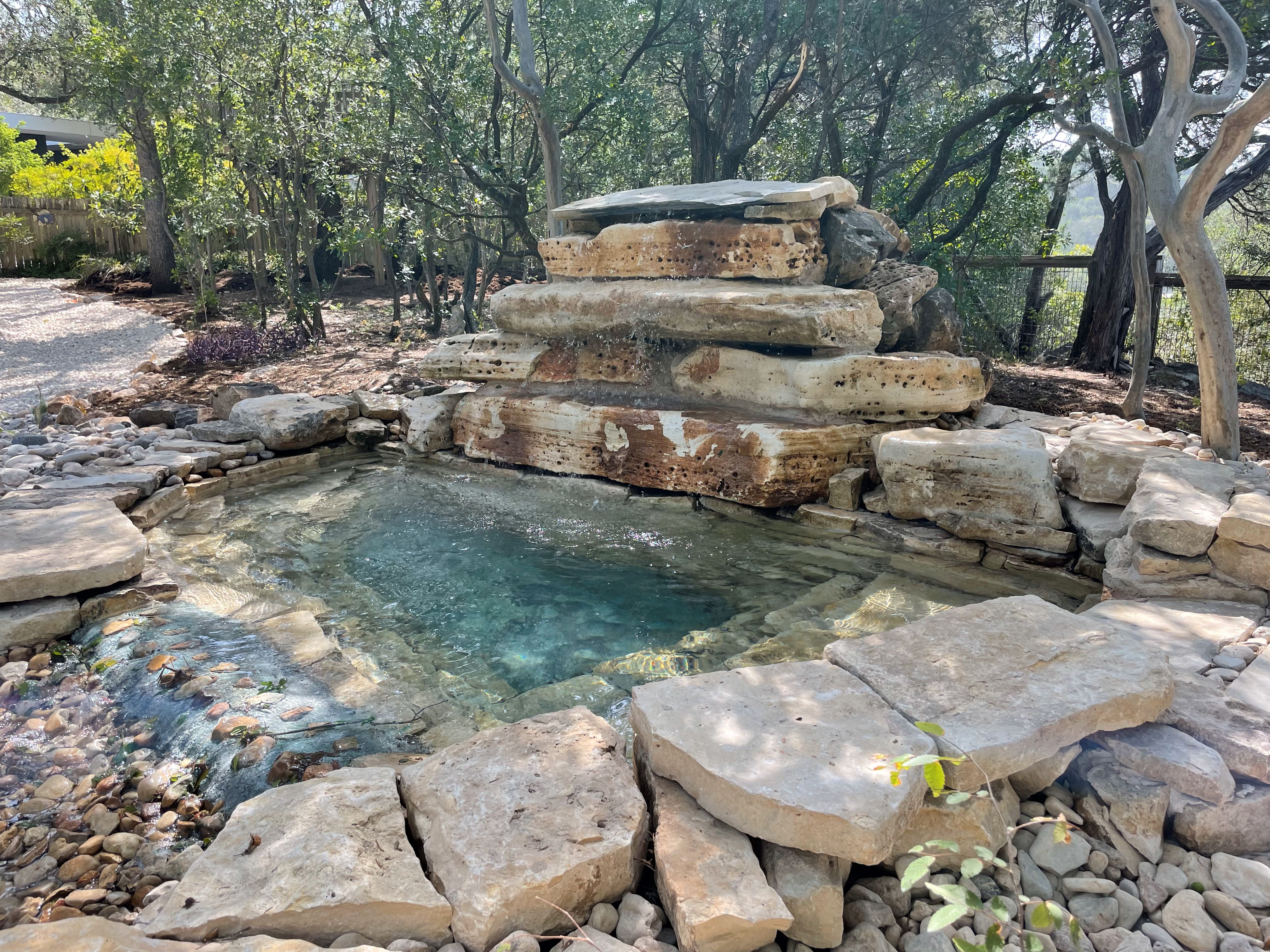 Boulder waterfall integrated with a swim spa