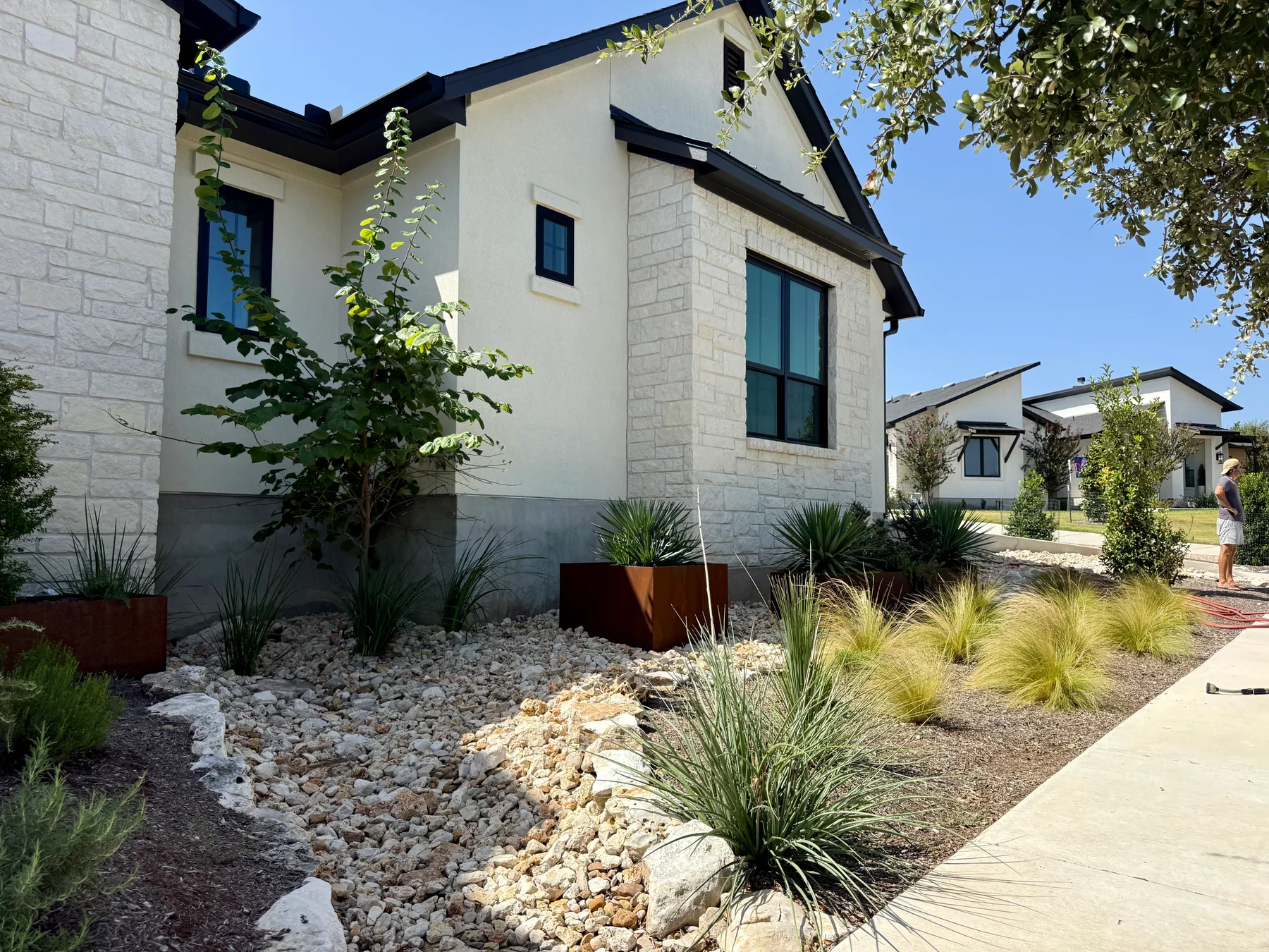 Steel planters and layered planting at a Hill Country home