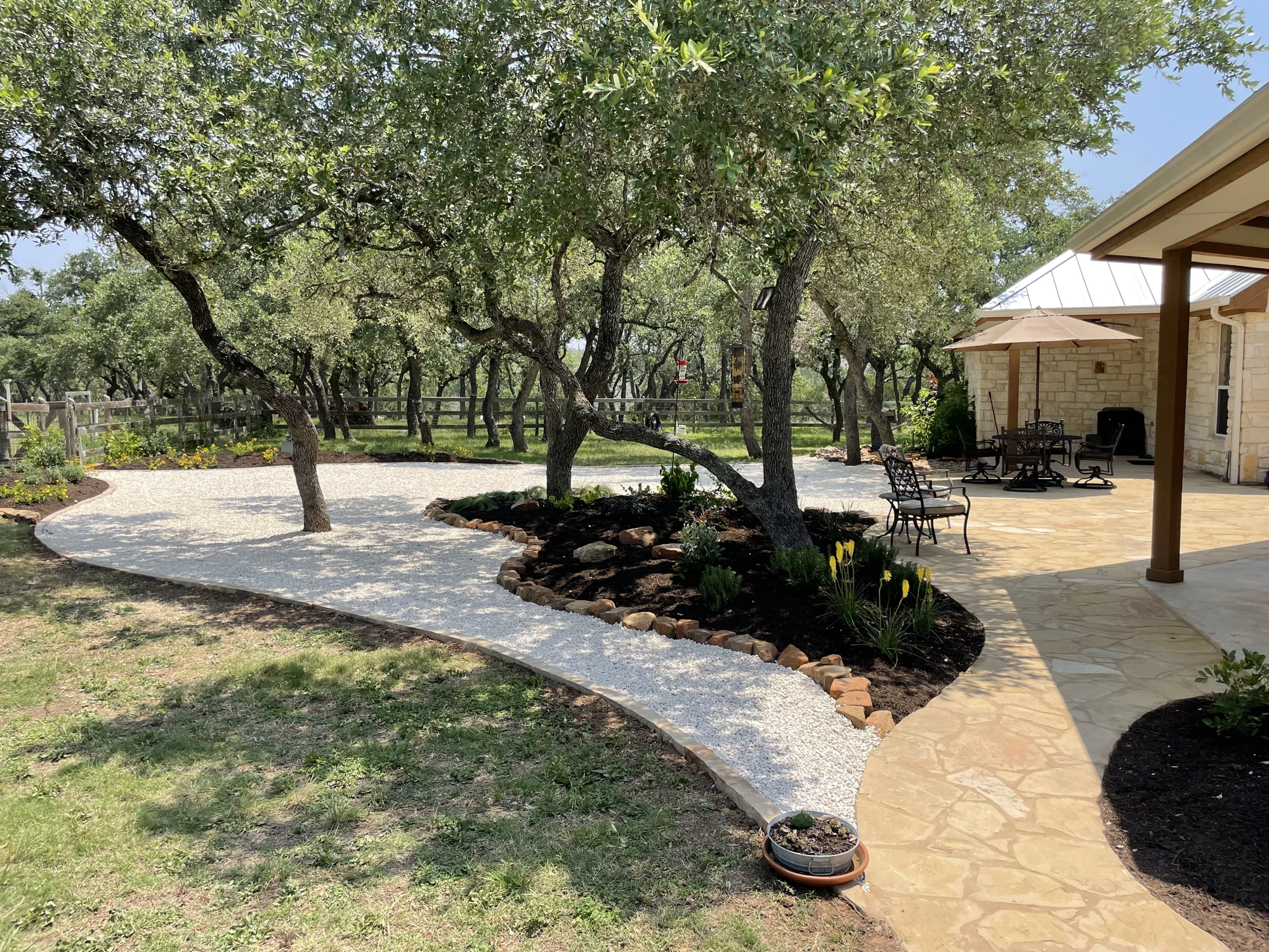 Masoned patio and curved path around established trees